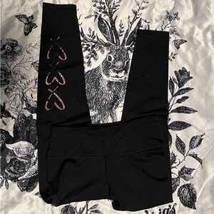 VS Victoria Sport Total Knockout Tight black heart leggings.